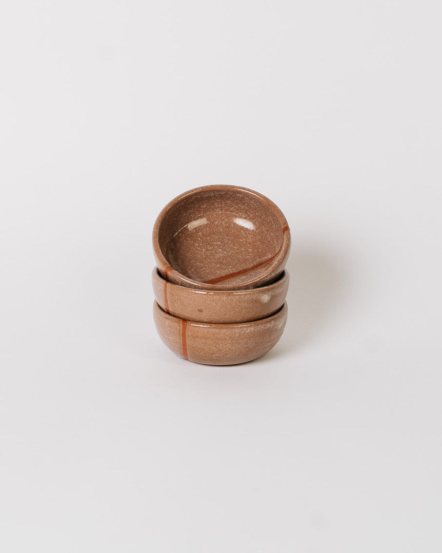 Stack of three ceramic bowls finished with a snowflake crackle glaze on a white background